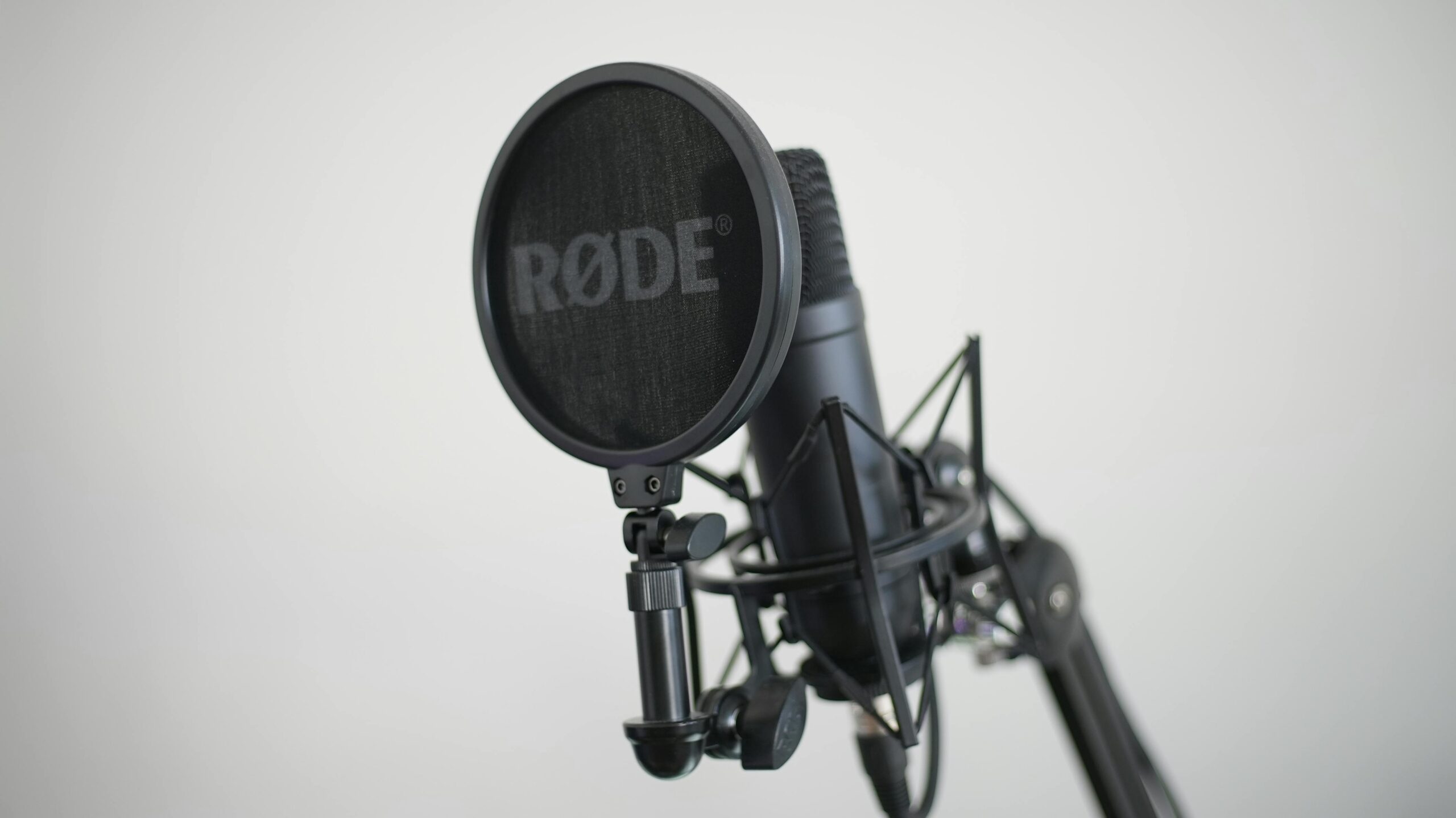 Close-up image of a condenser microphone with pop filter, ideal for music recording.